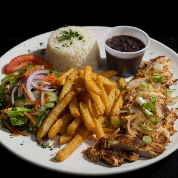 Grilled chicken with onions, fries, rice, black beans, and a fresh salad on a white plate.