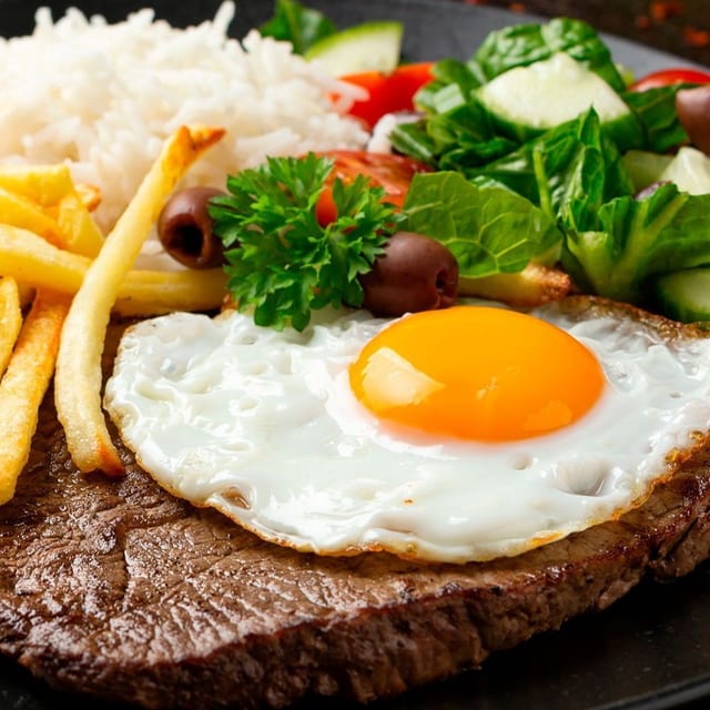 Bife a Cavalo (Steak with Fried Eggs).
